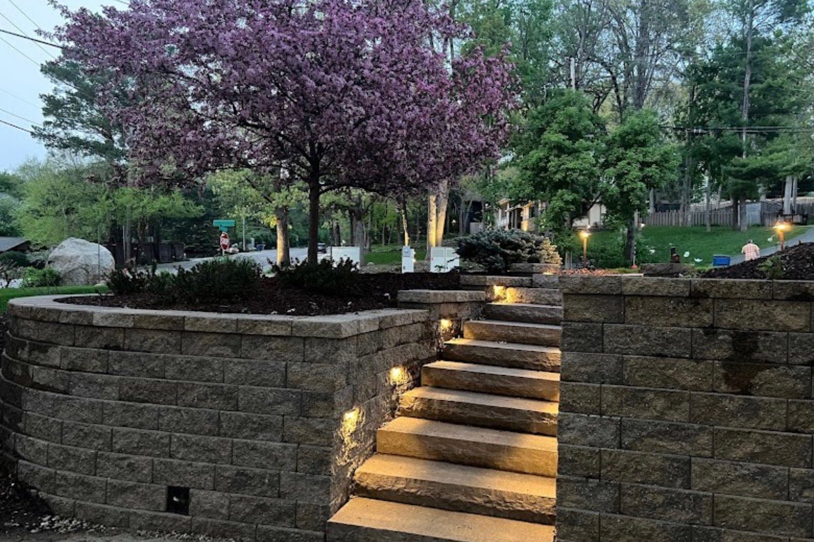 Tiered stone retaining walls and lit staircase — Going Yard hardscaping Edmonton
