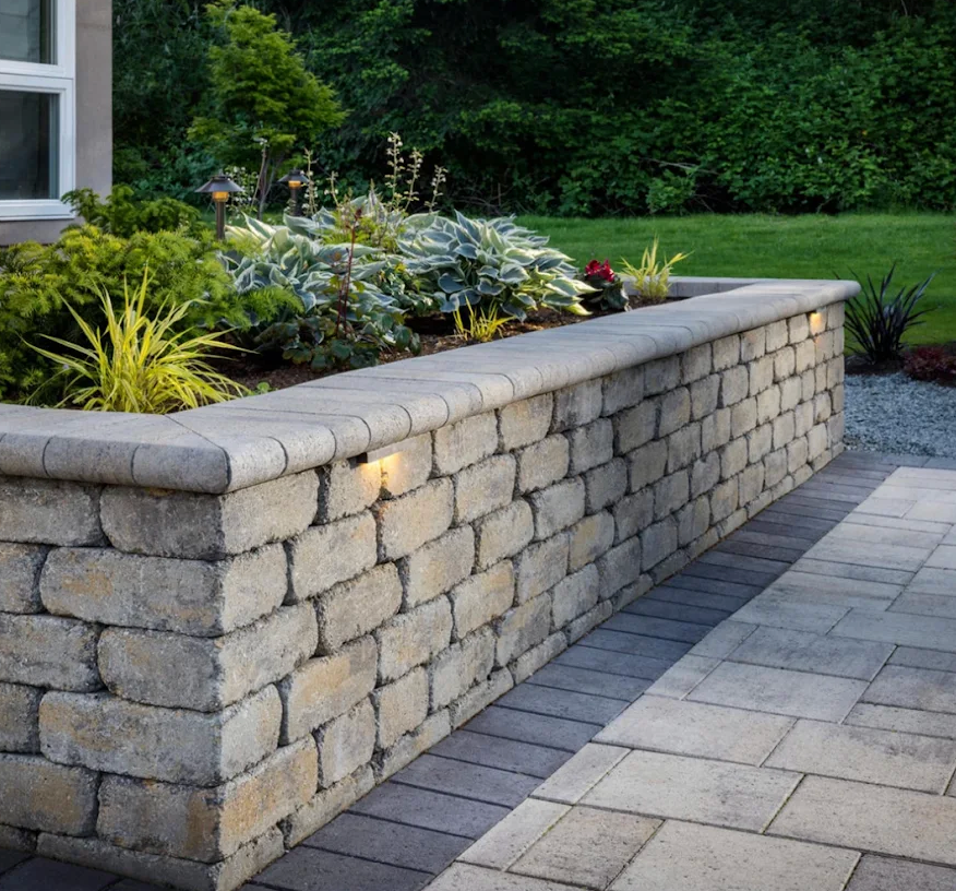 Stone retaining wall with integrated garden bed lighting — Going Yard hardscaping Edmonton