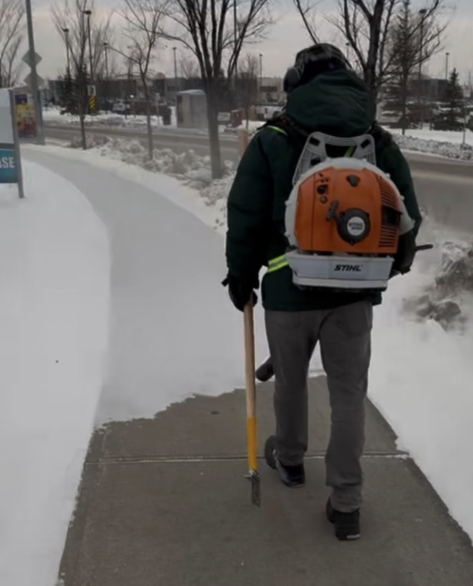 Residential snow removal crew clearing a St. Albert sidewalk  - Going Yard